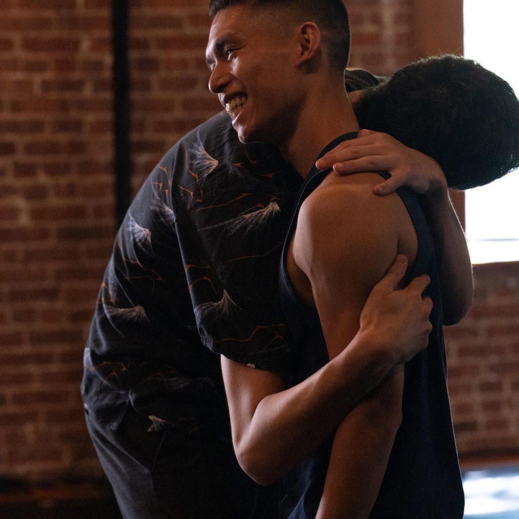 Jesse Obremski hugging Richard Sayama. Photo by McCall McClellan.